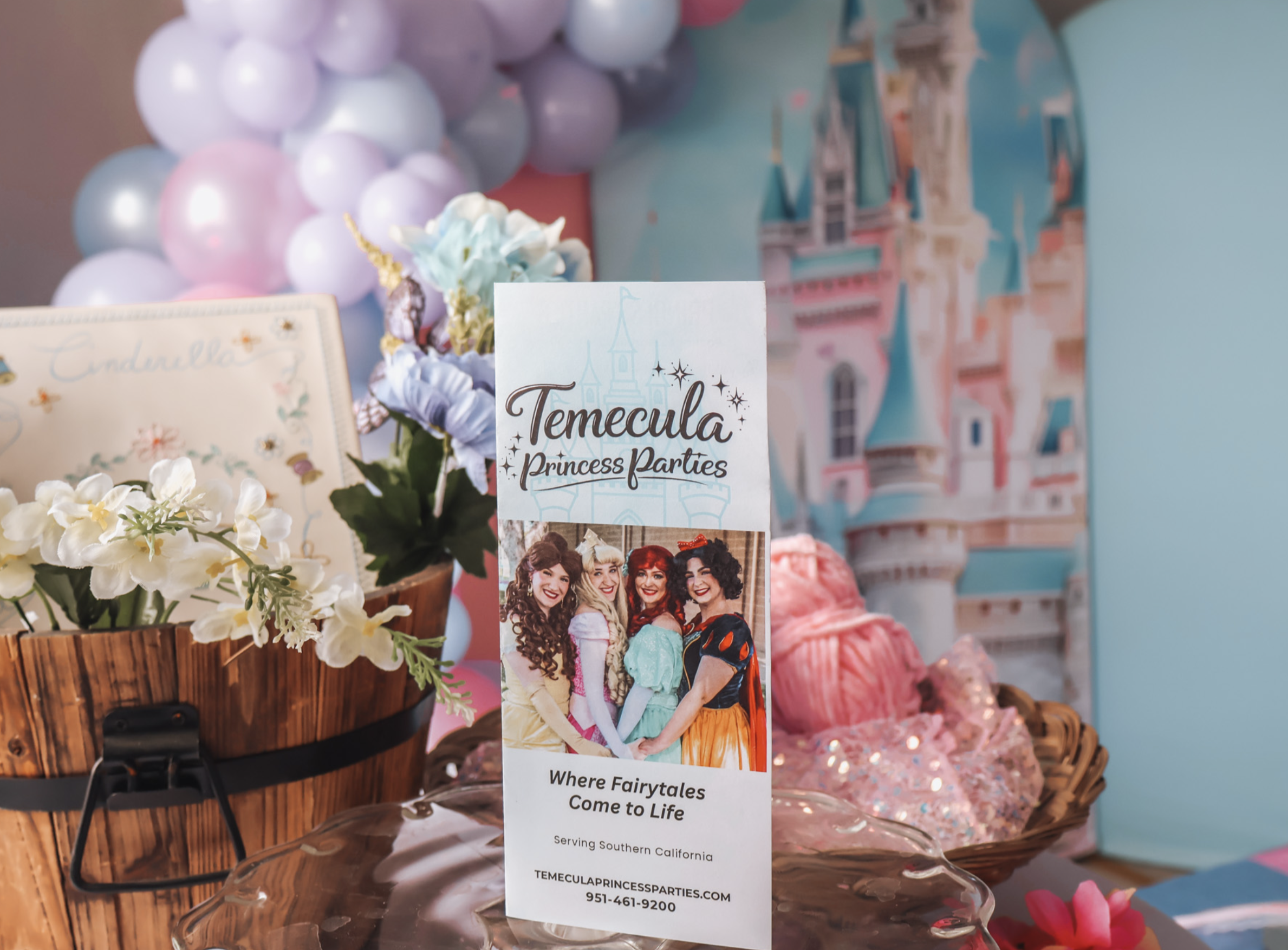 Temecula Princess Parties display with flowers, pastel balloons and a castle backdrop