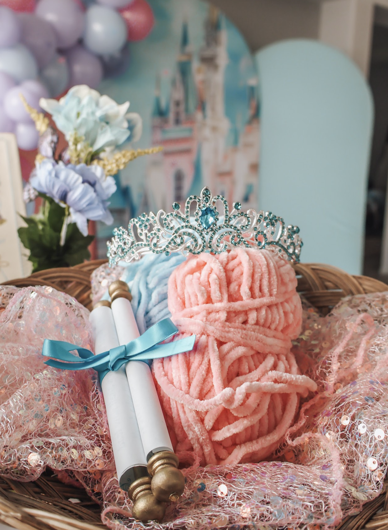 Jeweled tiara, ribbon-tied scroll and pastel decorative details at a princess party