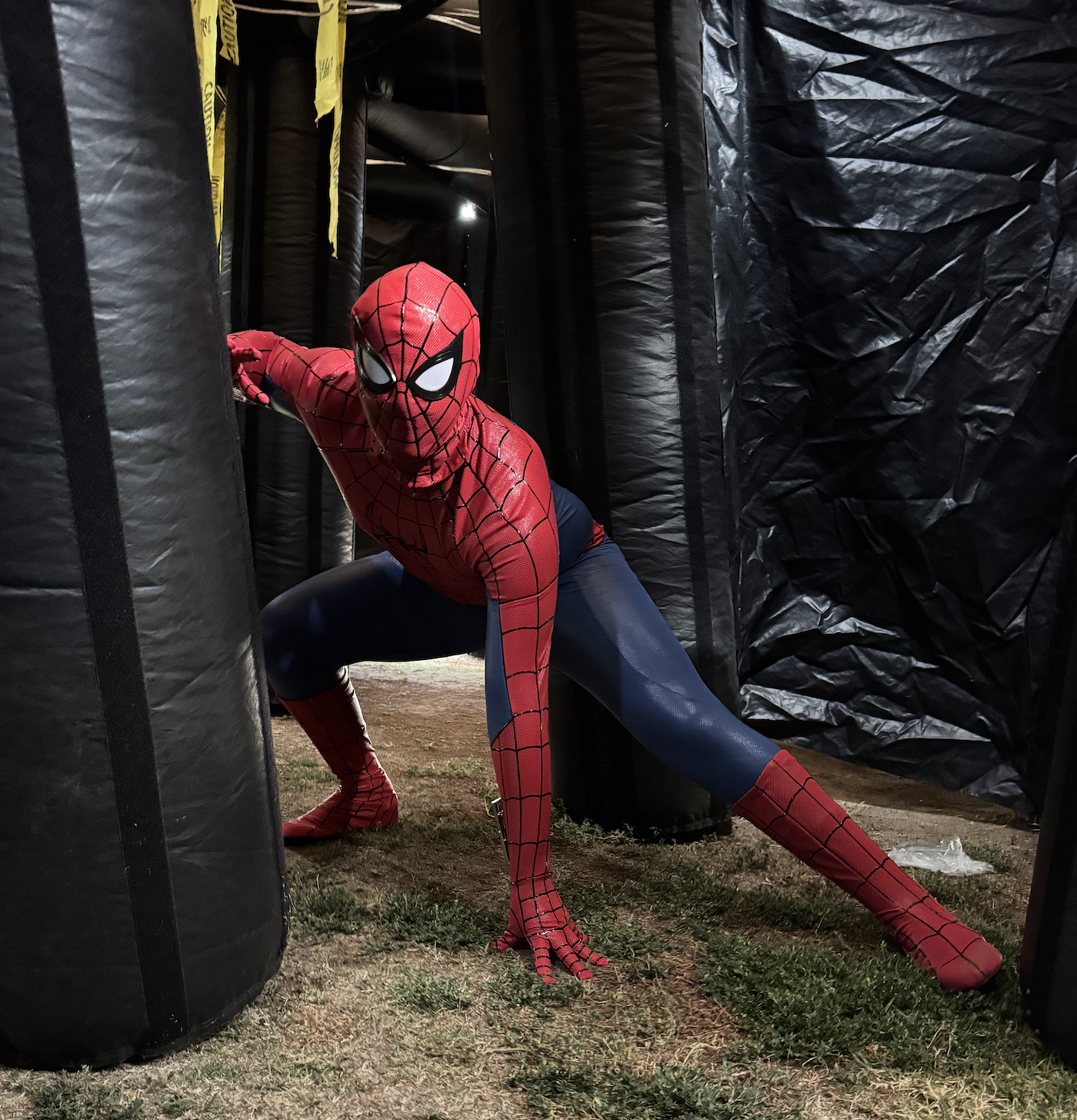 Spider-Man striking an action pose between inflatable maze walls