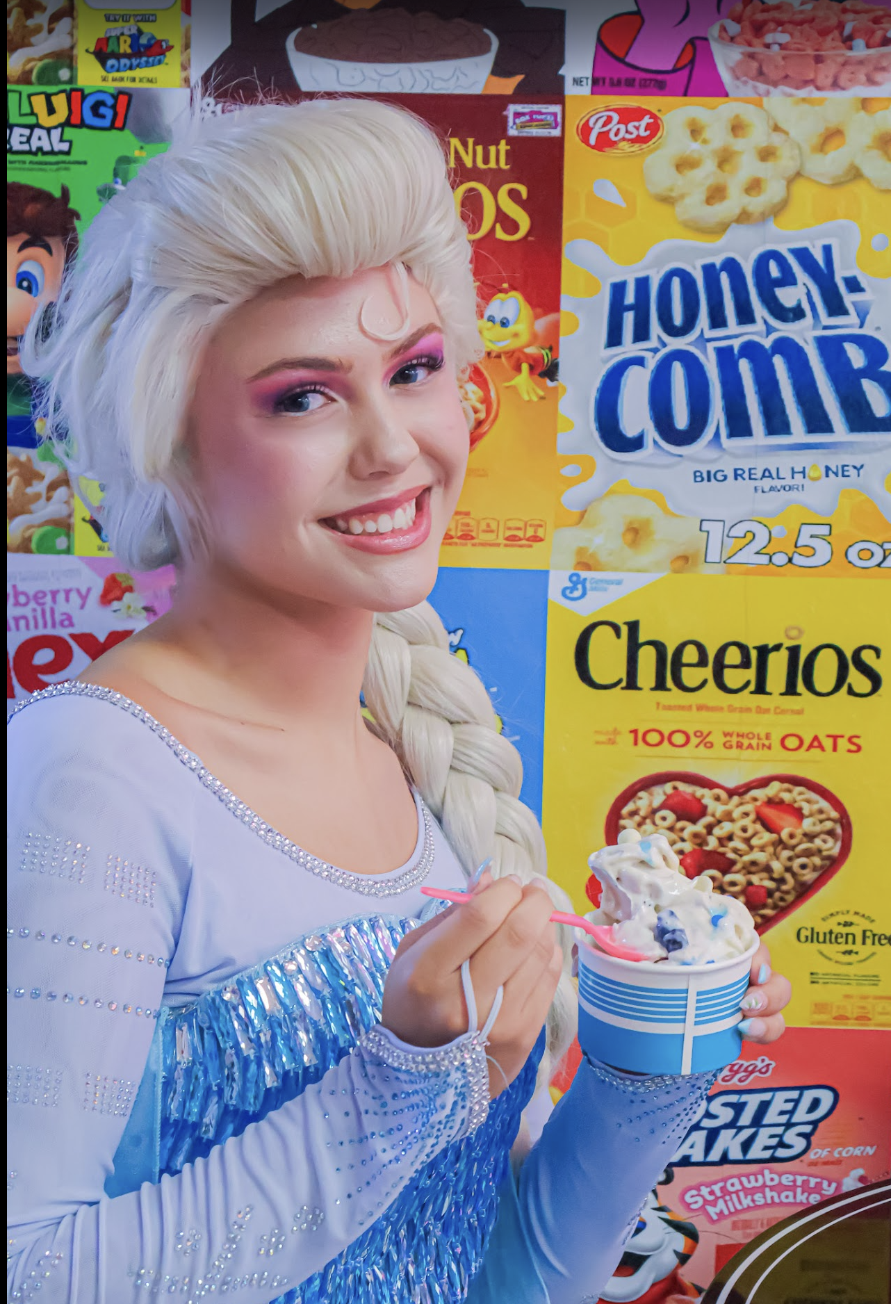 Elsa smiling in front of a colorful cereal-box display