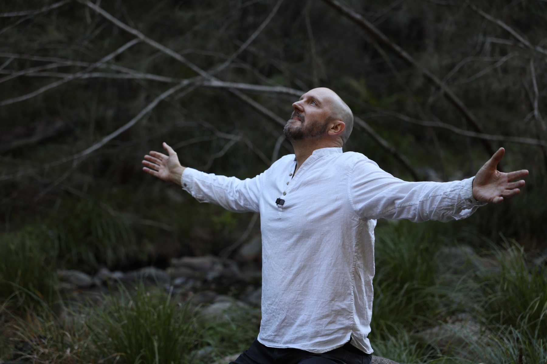 Chris in the forest, arms open