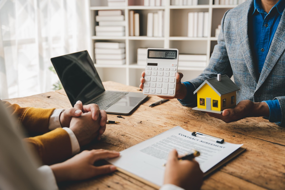 A broker walking a client through their loan paperwork
