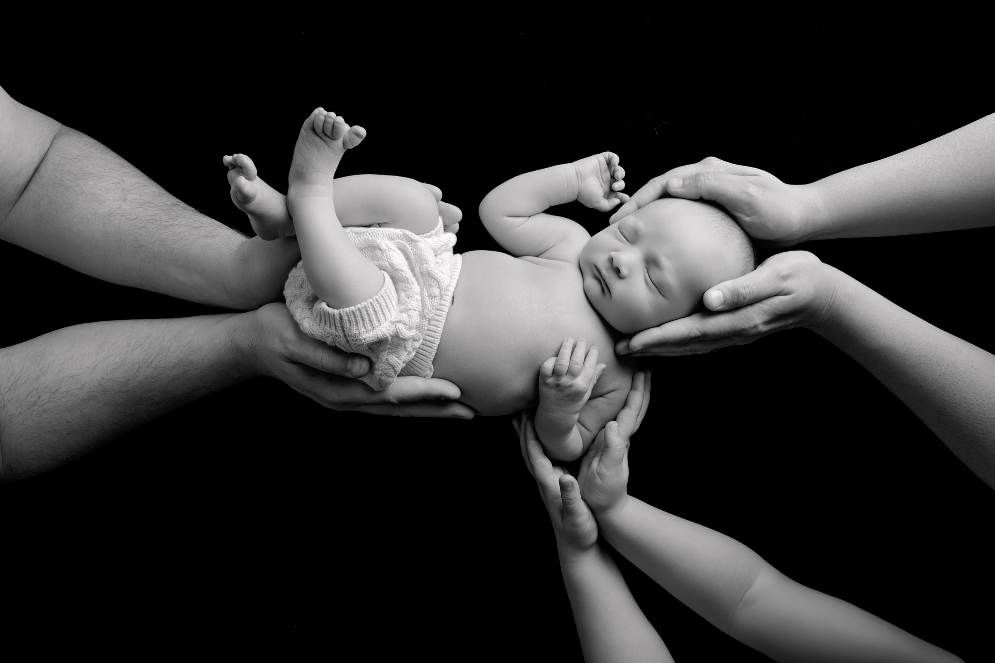 Newborn being held