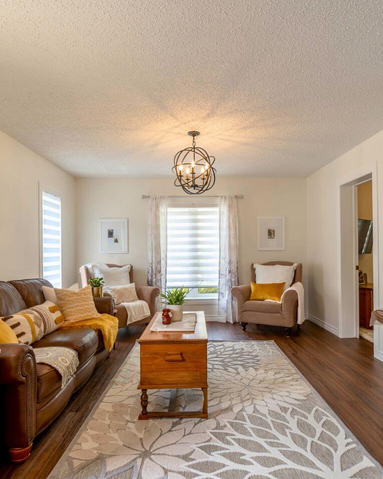  A beautifully staged living room by Interiors By Alanna in Kitchener-Waterloo, maximizing appeal for potential buyers. 