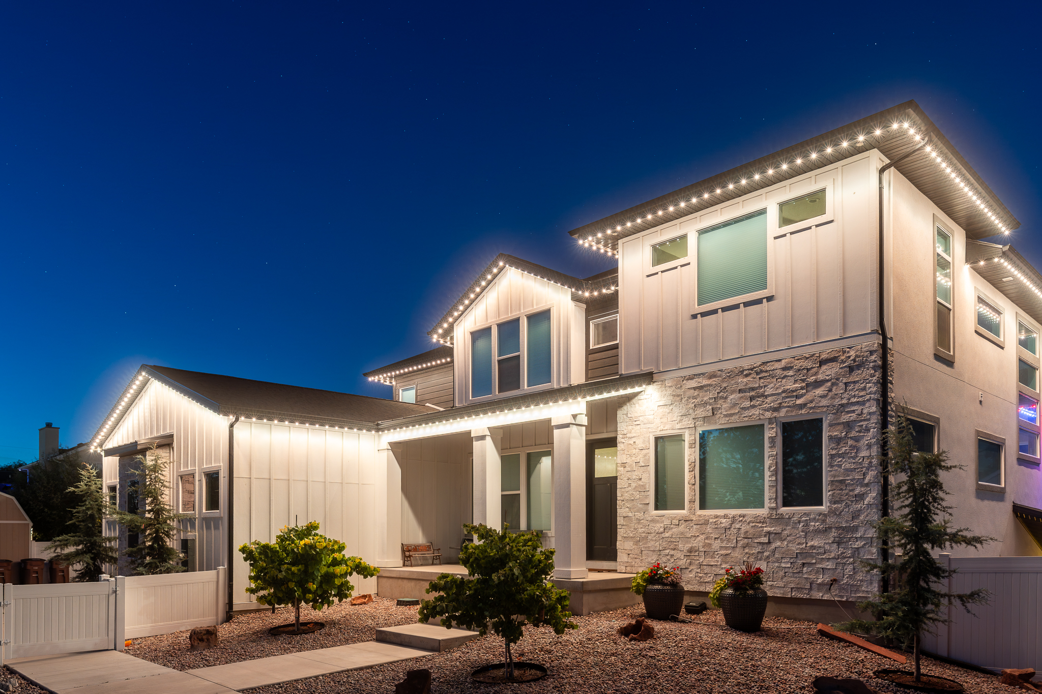 Home exterior at night with warm white lighting
