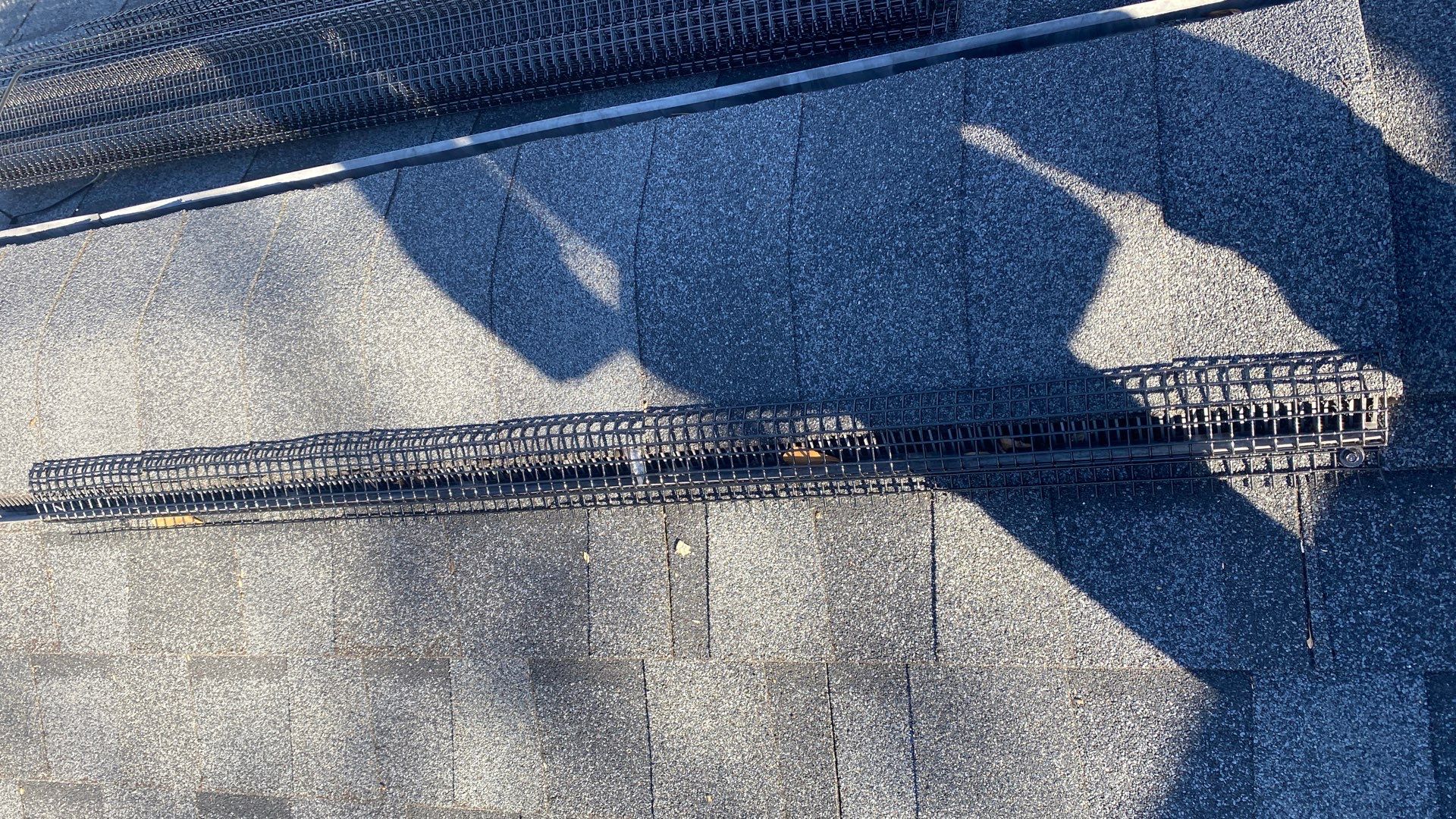 Wide-angle view of a Marietta roof ridge line with exclusion strip against the sky