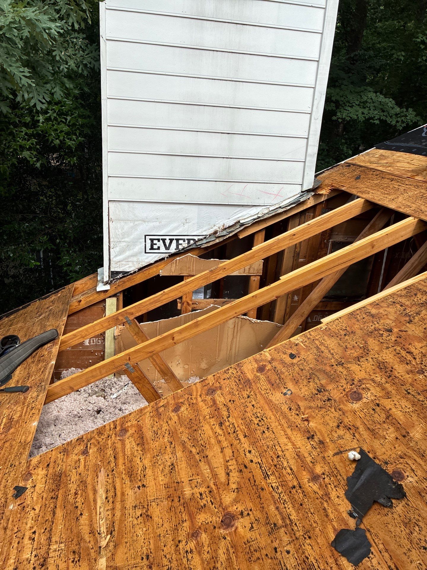 Exposed rafters and decking mid-repair on a Marietta home