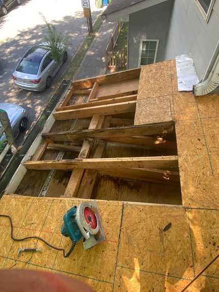 Bare roof decking exposed during an asphalt shingle tear-off in Marietta, GA