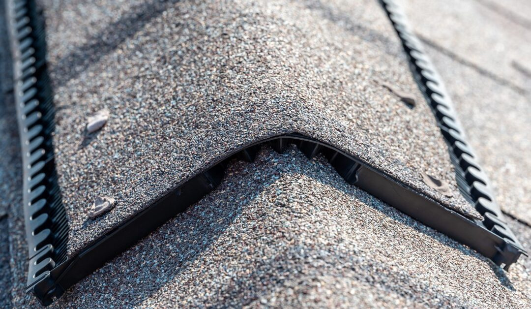Close-up of a shingle-over ridge vent running along the peak of a roof