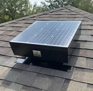 Solar attic fan angled on a roof plane