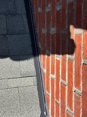 Shadowed detail of brick chimney flashing