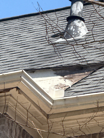 Rotted fascia board with a gutter pulling away from the roofline