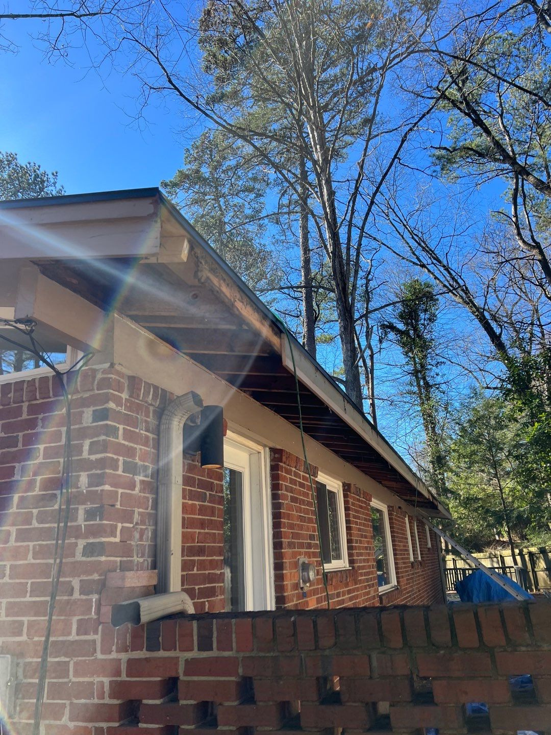 Technician documenting fascia damage with a photo