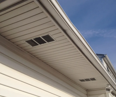 New fascia board installed along a roof edge with gutter attached
