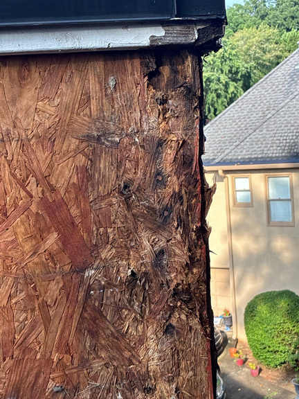 Close-up of rotted wood fiber at a roof edge