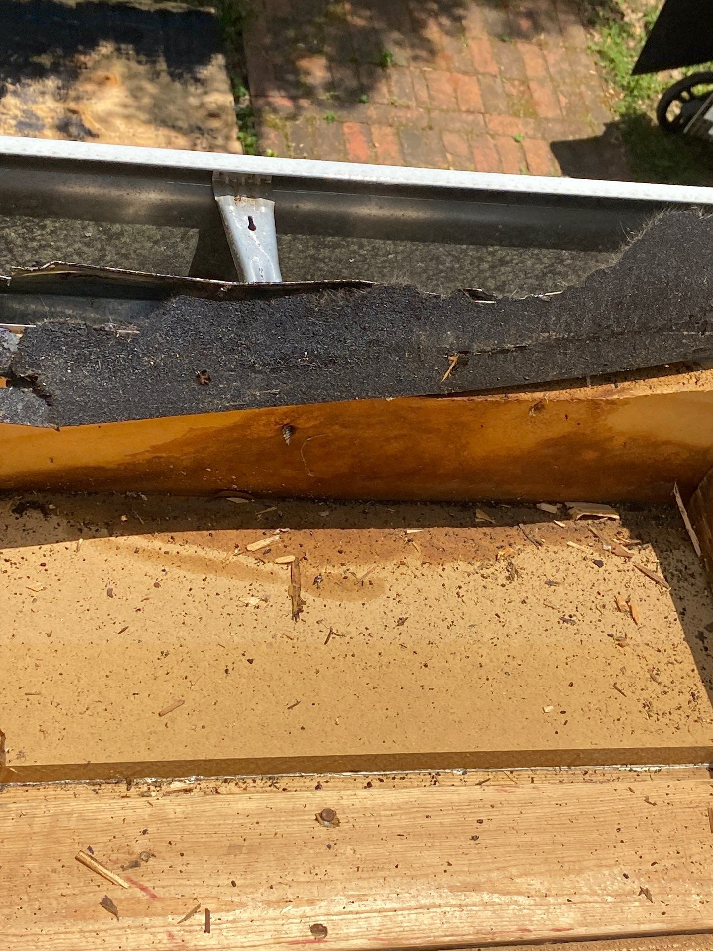 Exposed fascia and roof edge with brick pavers visible below
