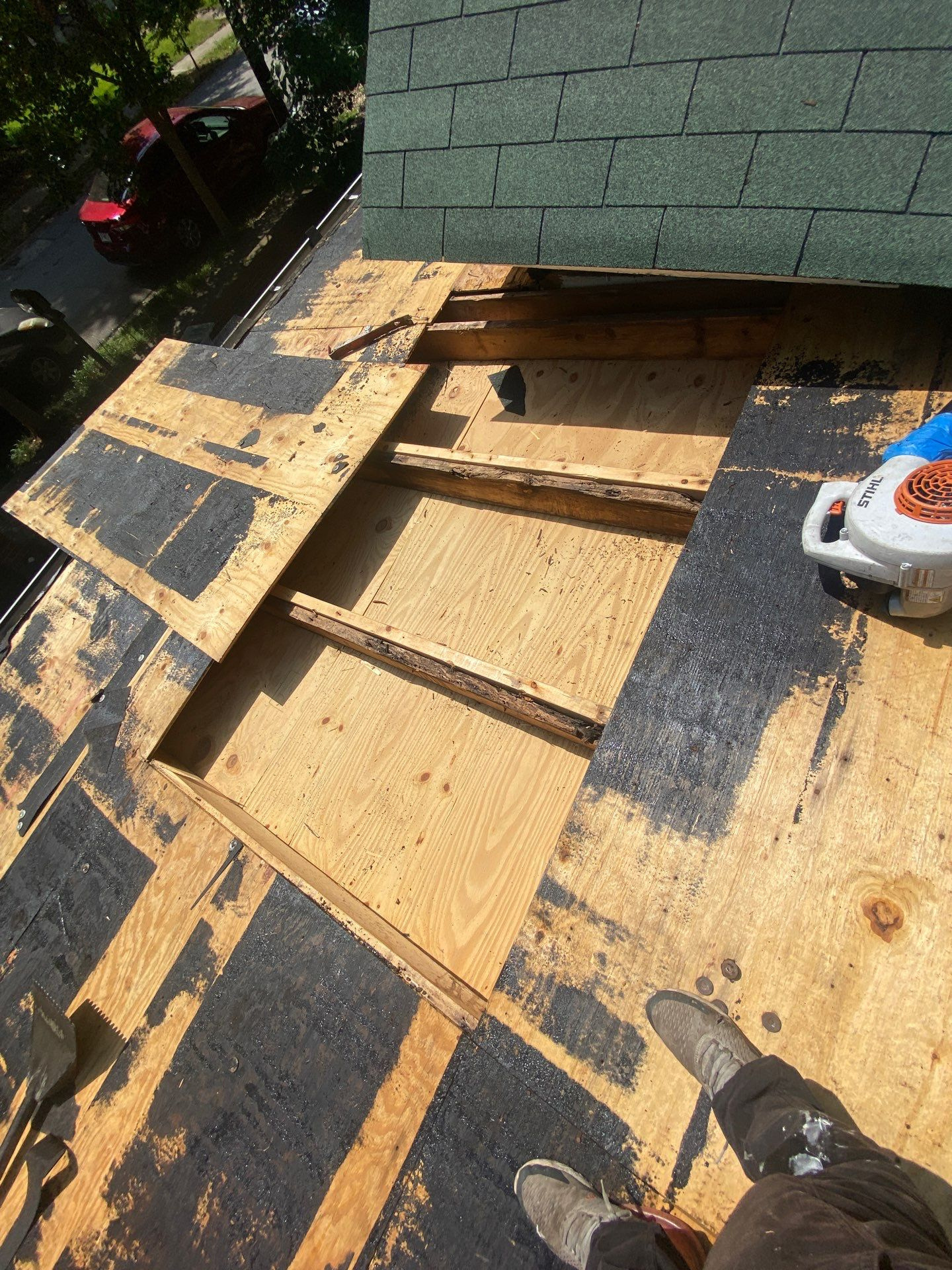 Exposed roof decking showing wood rot damage at the roofline