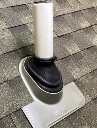 New rubber pipe boot installed around a roof vent pipe