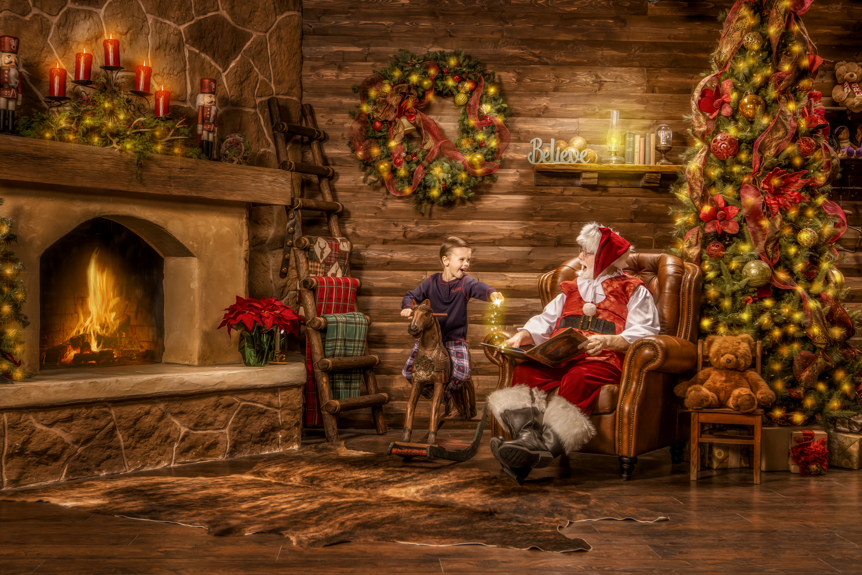 Santa Mike teaching a young boy how to make Christmas magic in the 2021 Magic of Santa experience