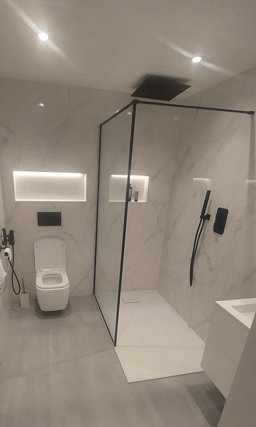 Small bathroom with shower and open floor area that improves movement through the room
