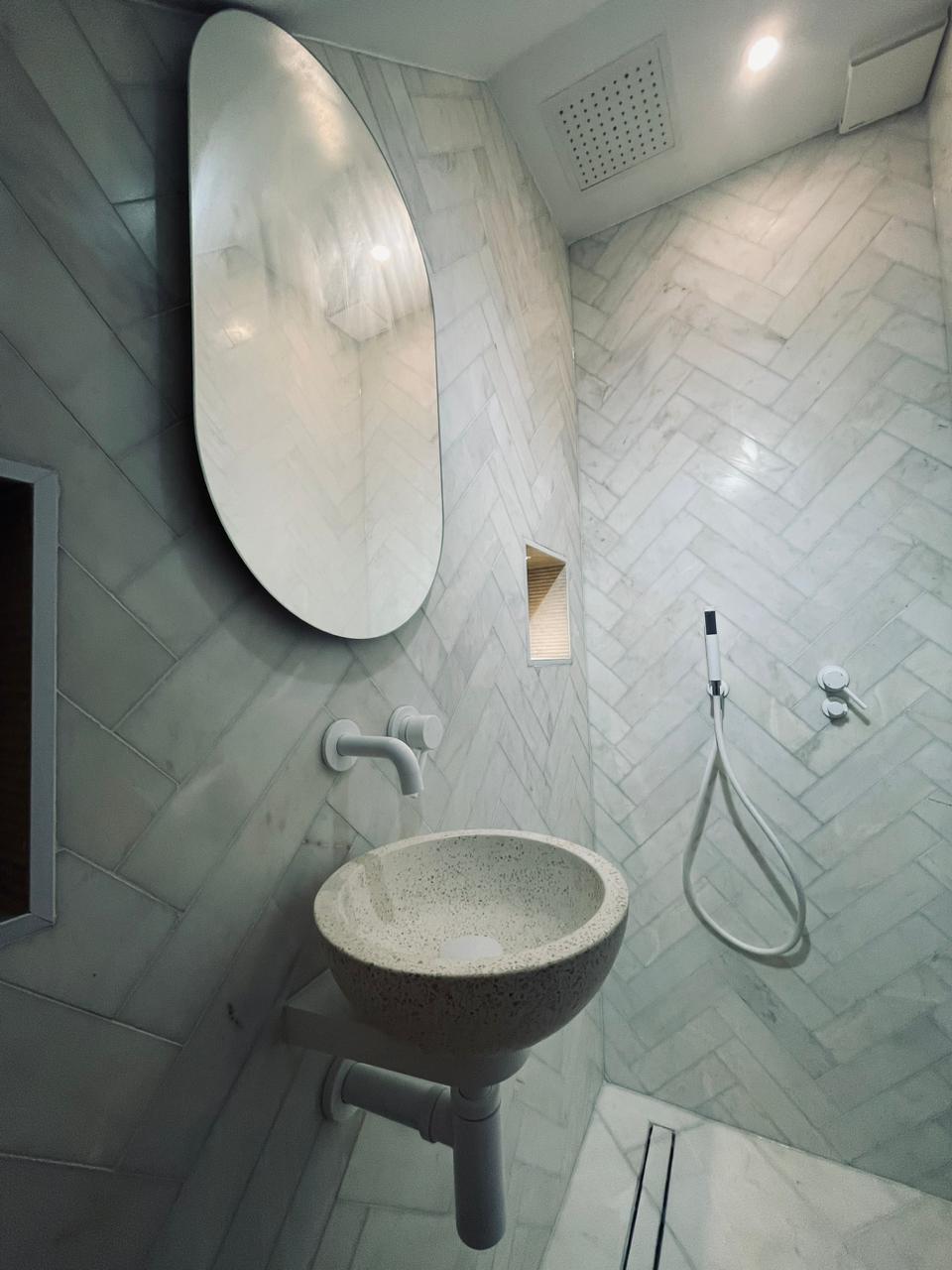 Small bathroom with a walk-in shower, floating vanity and light neutral finishes