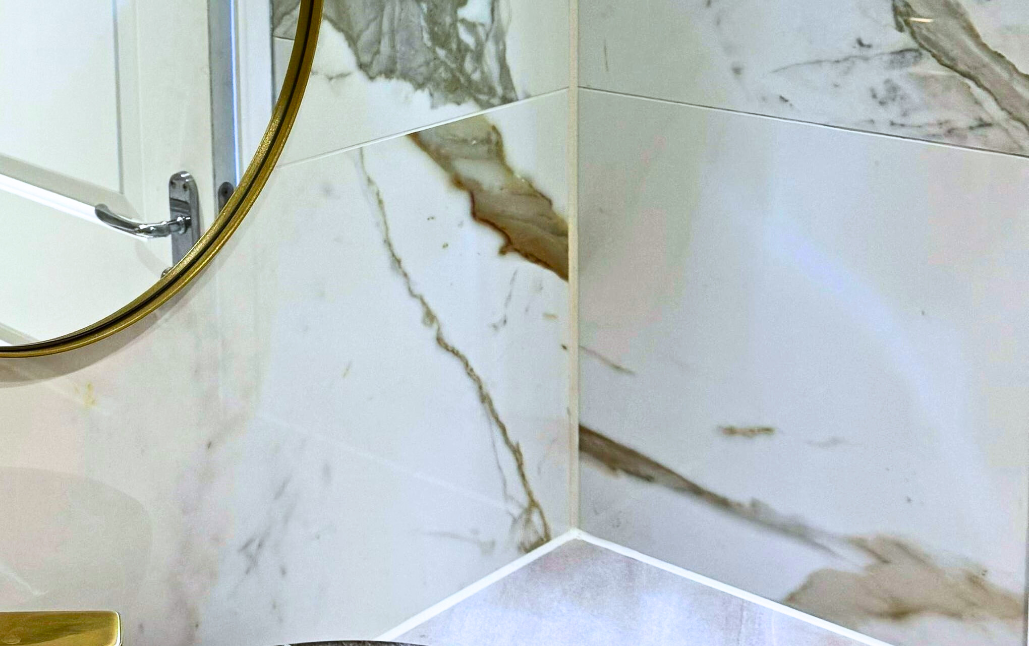 Bathroom wall tiles in a neutral stone effect finish