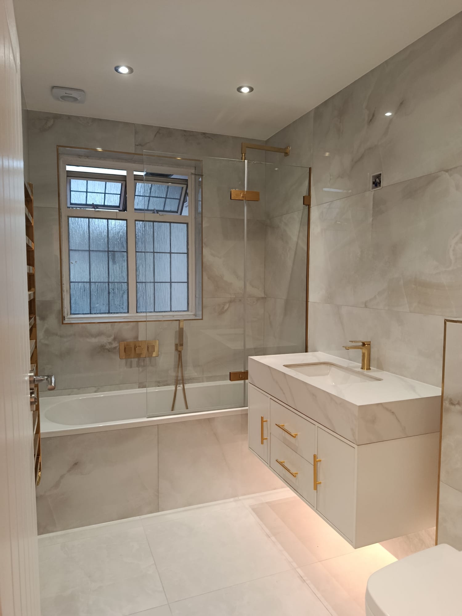 Small bathroom with warm neutral tile colours