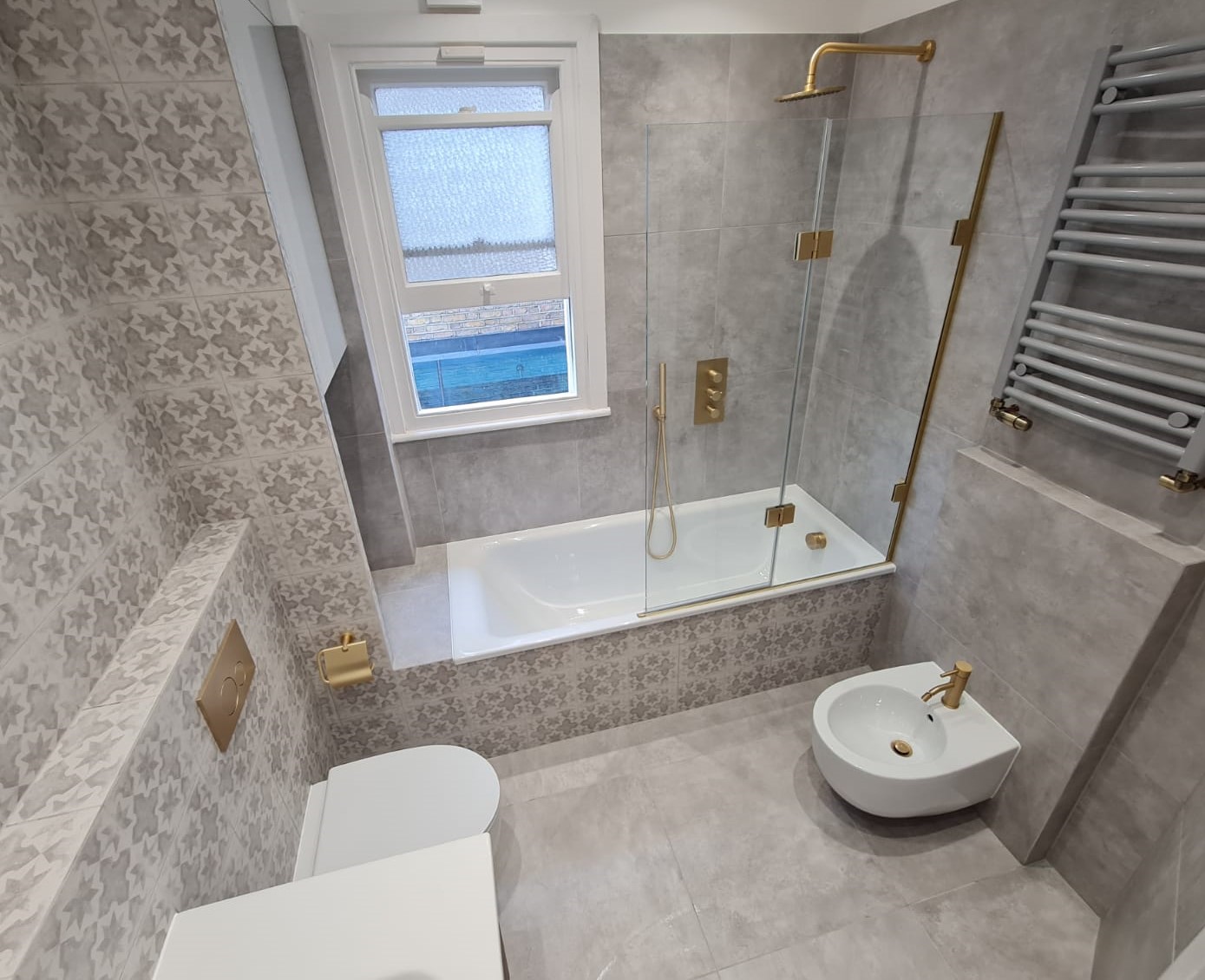 Soft grey bathroom tile palette in a small bathroom