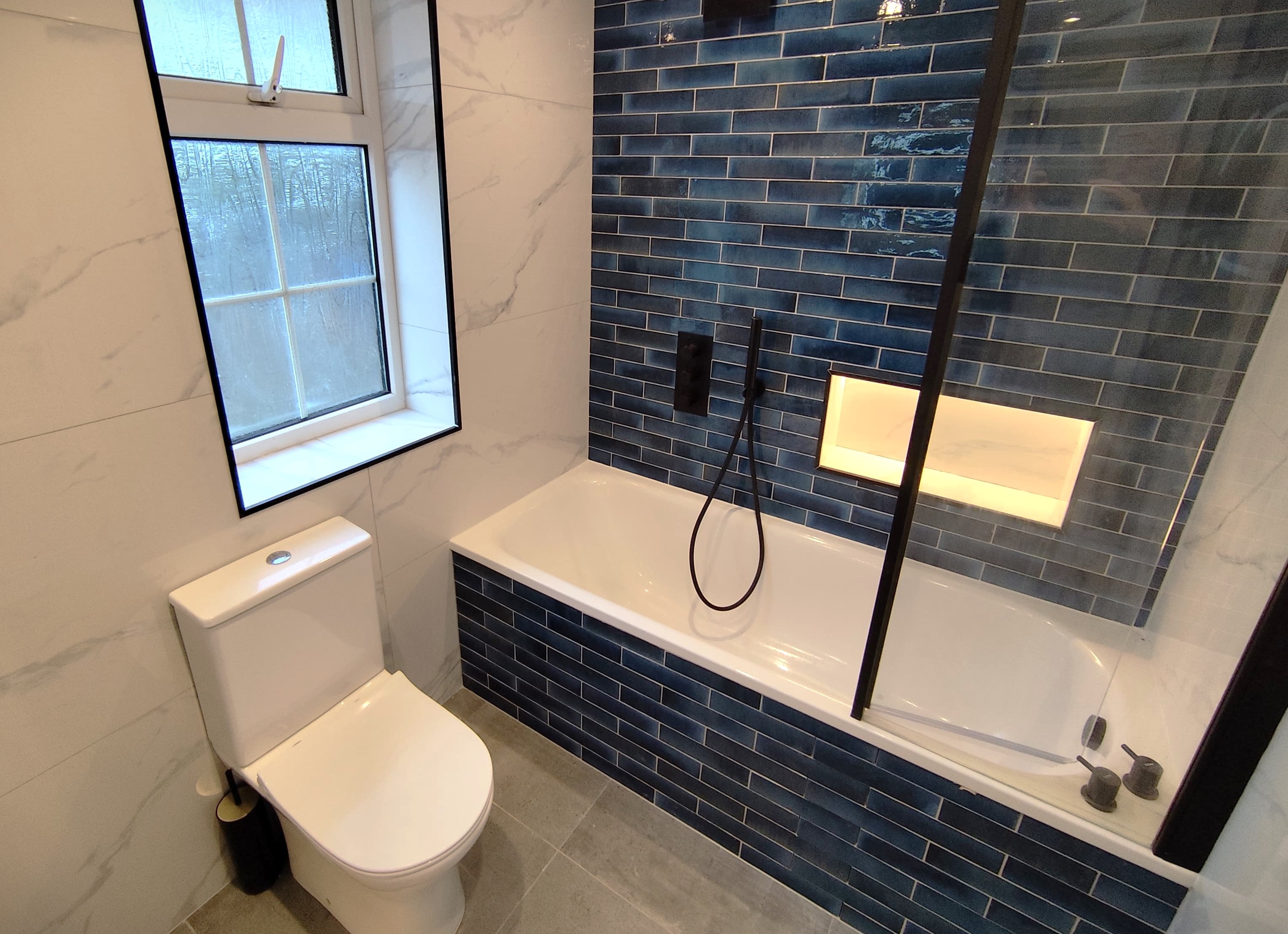 Shower-led bathroom with clean glass and open circulation space