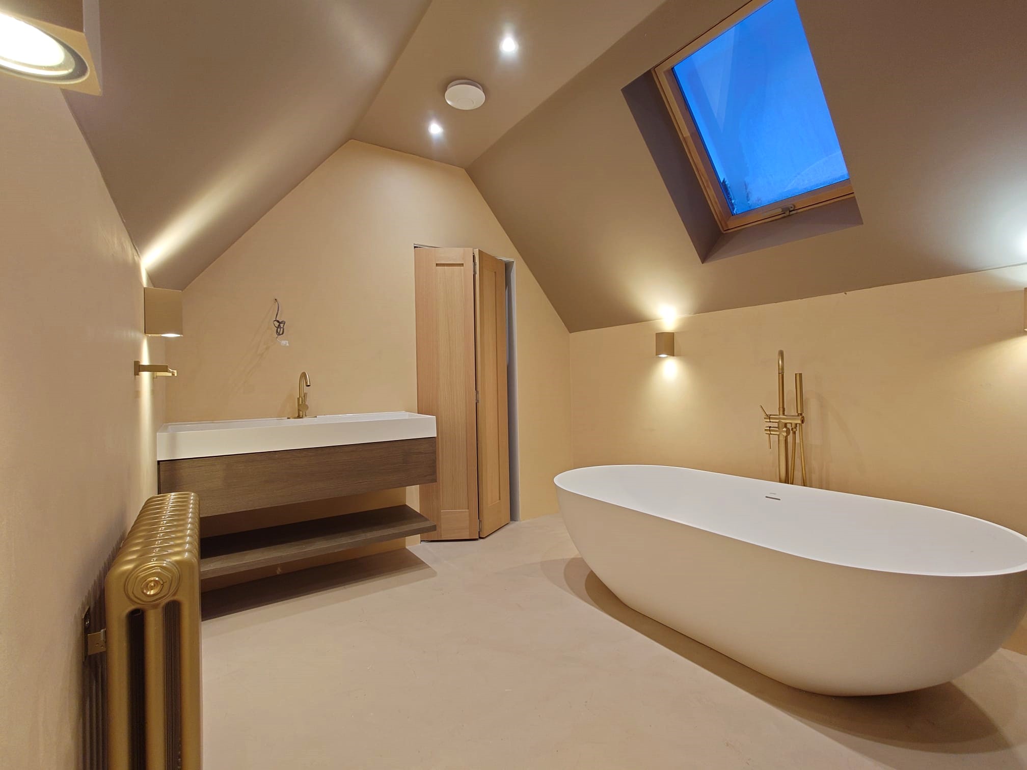 Bathroom with layered lighting and backlit mirror