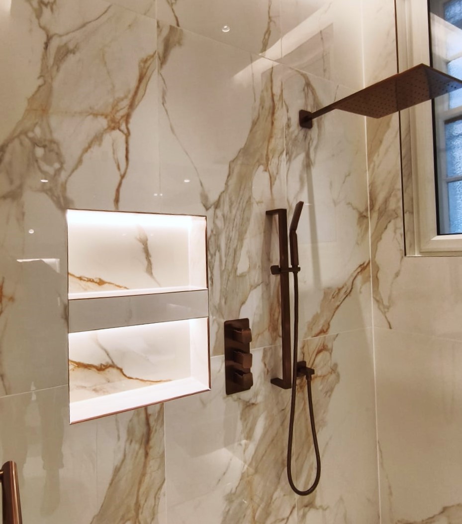 Built-in shower niche aligned with bathroom tiles