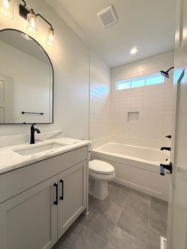Coordinated bathroom tiles across walls floors and shower area