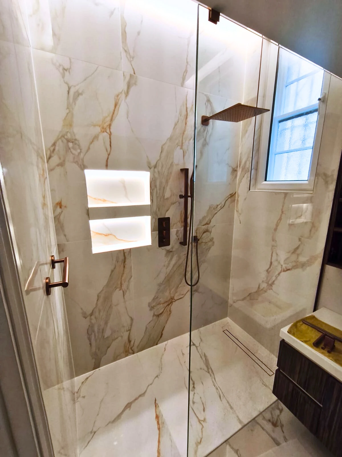 Tiled shower area with wall and floor finishes