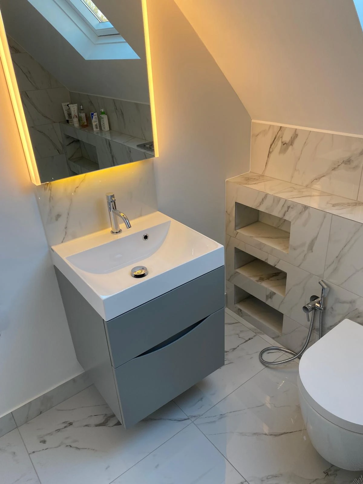 Small bathroom storage ideas with recessed shelving, compact vanity storage and integrated design details