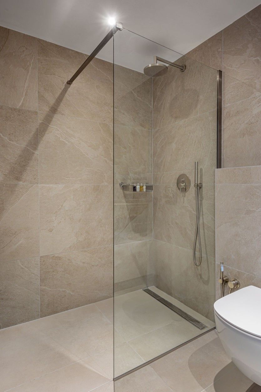 Bathroom shower area blending into wider tile palette