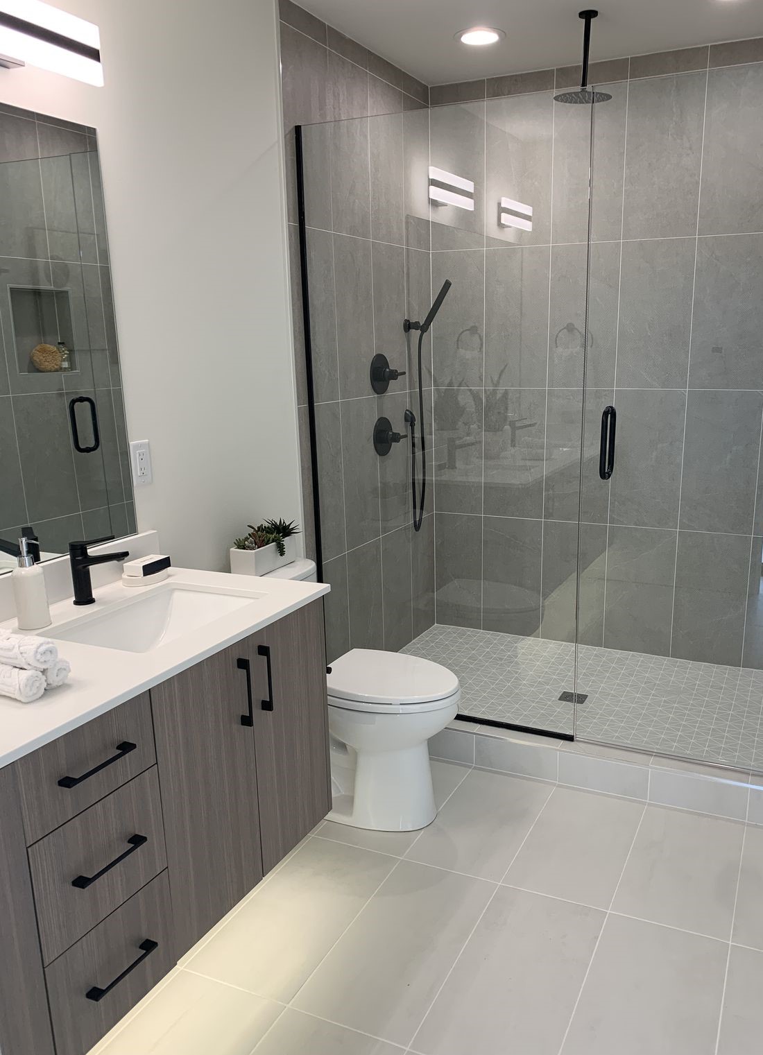 Unified bathroom tile scheme across walls floors and shower