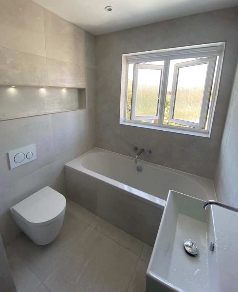 Compact bathroom layout showing circulation space around bath and shower fittings