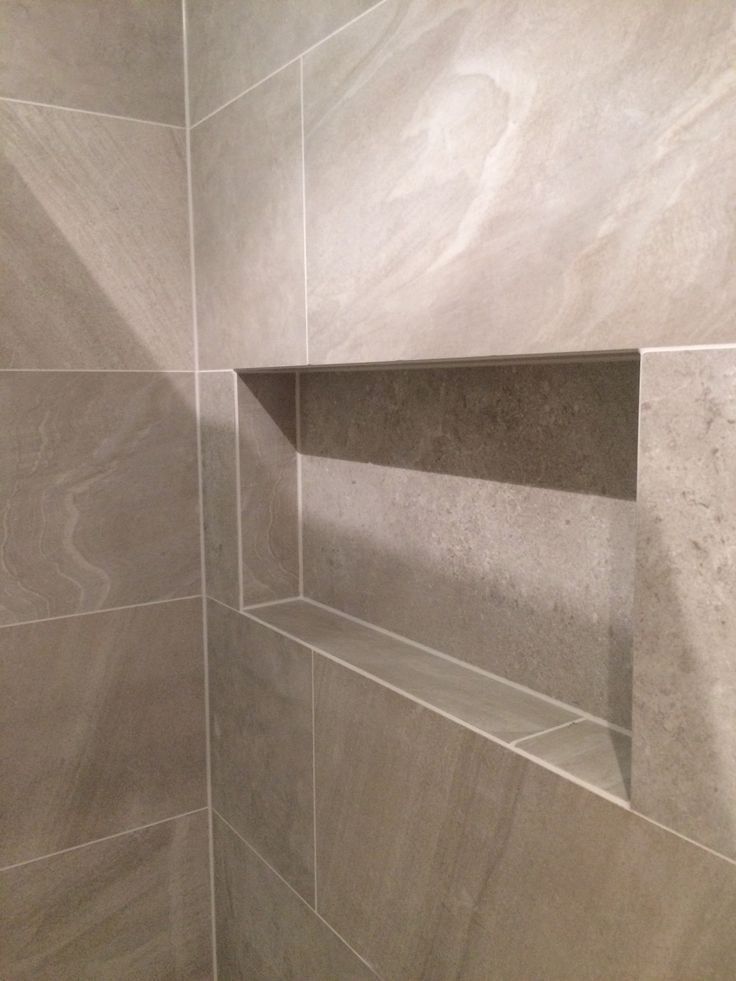 Built-in shower shelf aligned with bathroom tiles