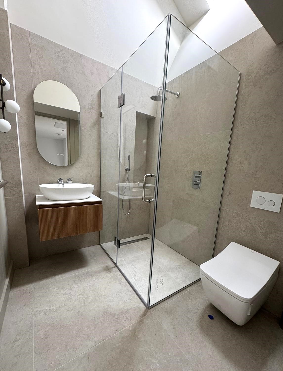 Small bathroom layout with clear circulation and storage