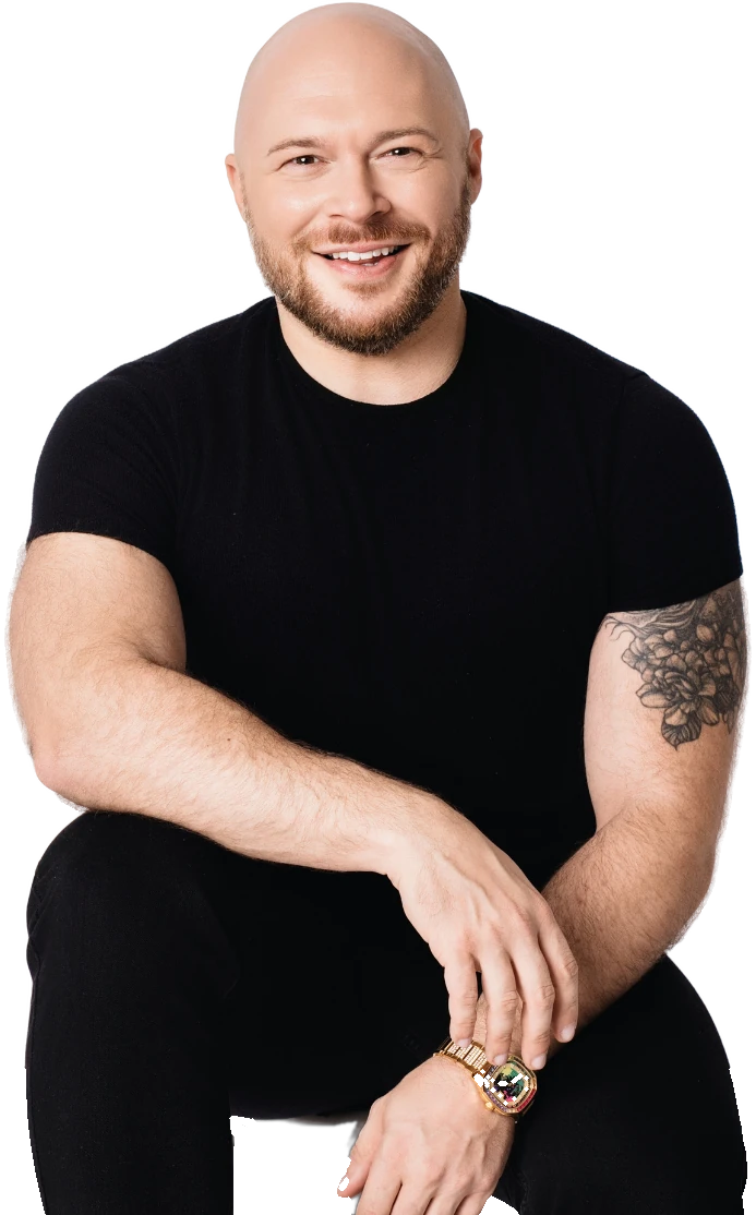 Travis Holp smiling in a black t-shirt