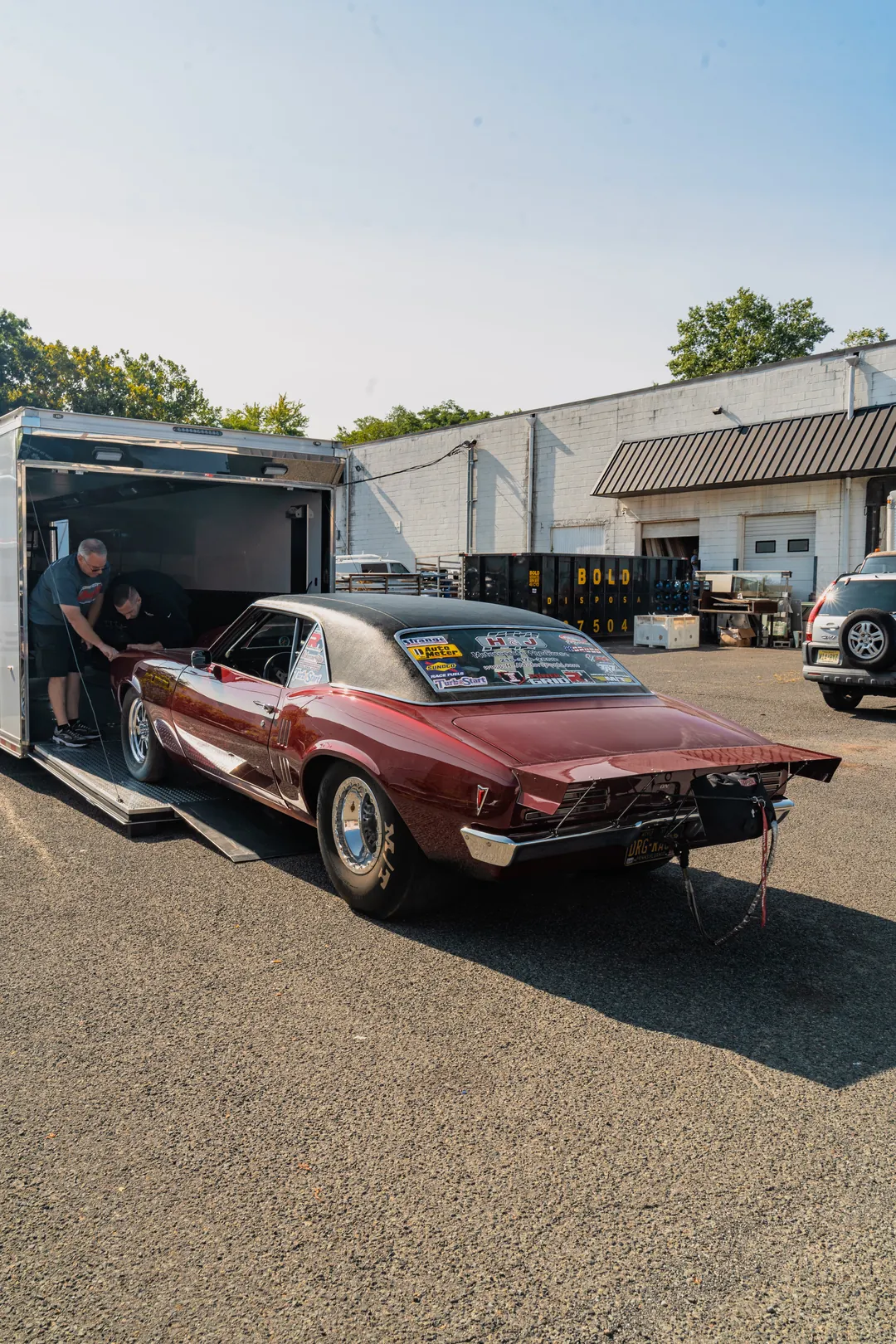 Classic car arriving on a trailer at the studio