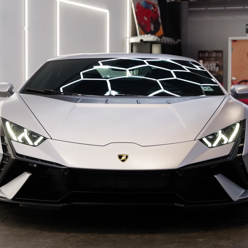 Grey Lamborghini Huracán Tecnica, the hexagonal lights reflected in its windshield