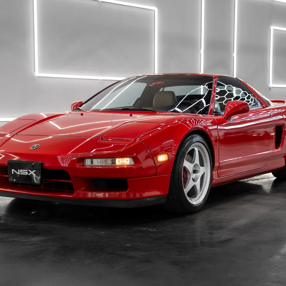 Red 1995 Acura NSX under the hexagonal lights