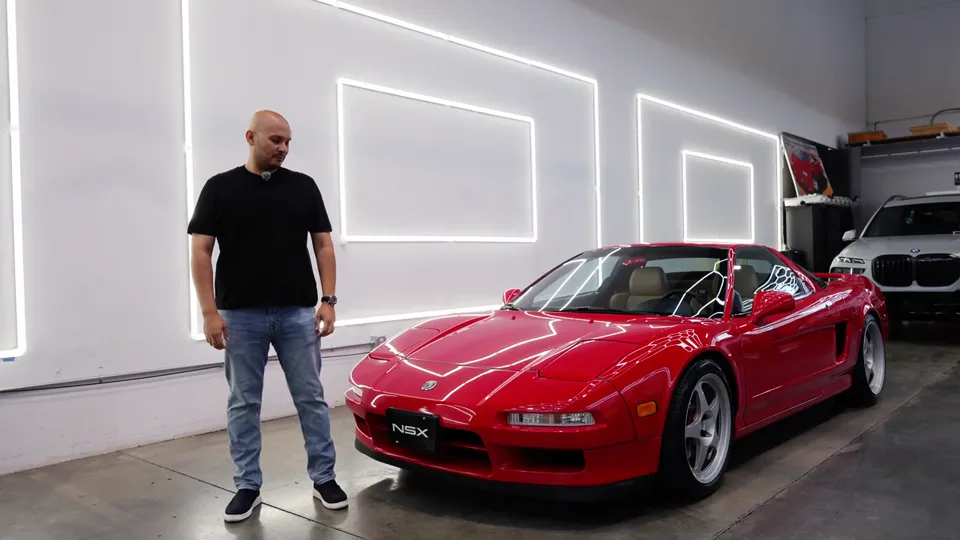 Luis next to his red 1995 Acura NSX in the studio