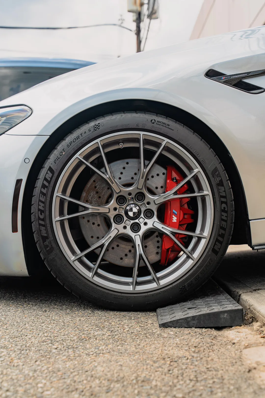 BMW wheel with red brake caliper after detailing