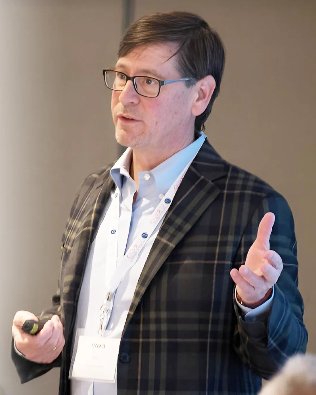 David Lund, The Hotel Financial Coach, speaking on stage at a hospitality leadership conference