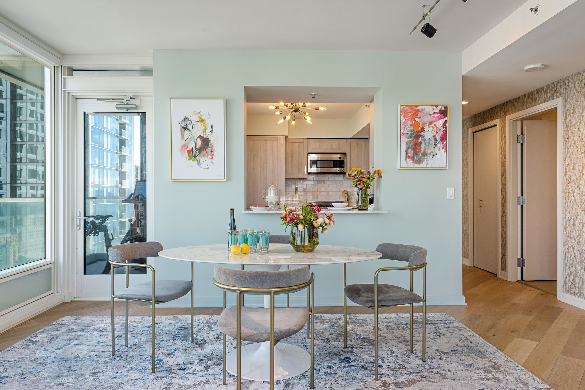 Light-filled dining area with table, seating and coordinated finishes