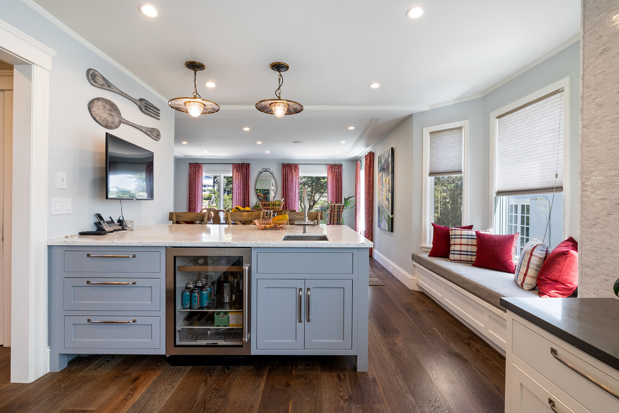 Butler's pantry and bar area with cabinetry, pendant lighting and beverage fridge