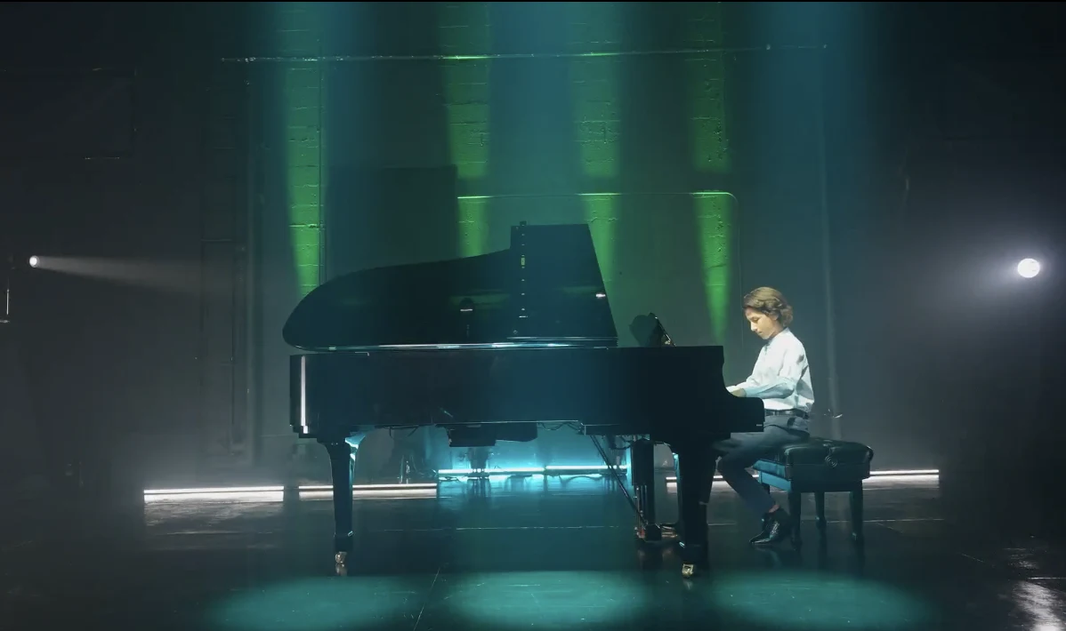 Pianist performing at a grand piano