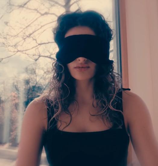 A sighted woman wearing the training mask